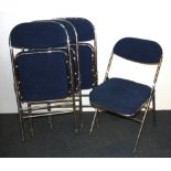 A set of four upholstered chrome folding chairs.