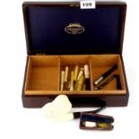 A box of mixed tobacco pipes and cigarette holders.