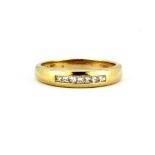 A 14ct yellow gold ring set with princess cut diamonds, (T.5).