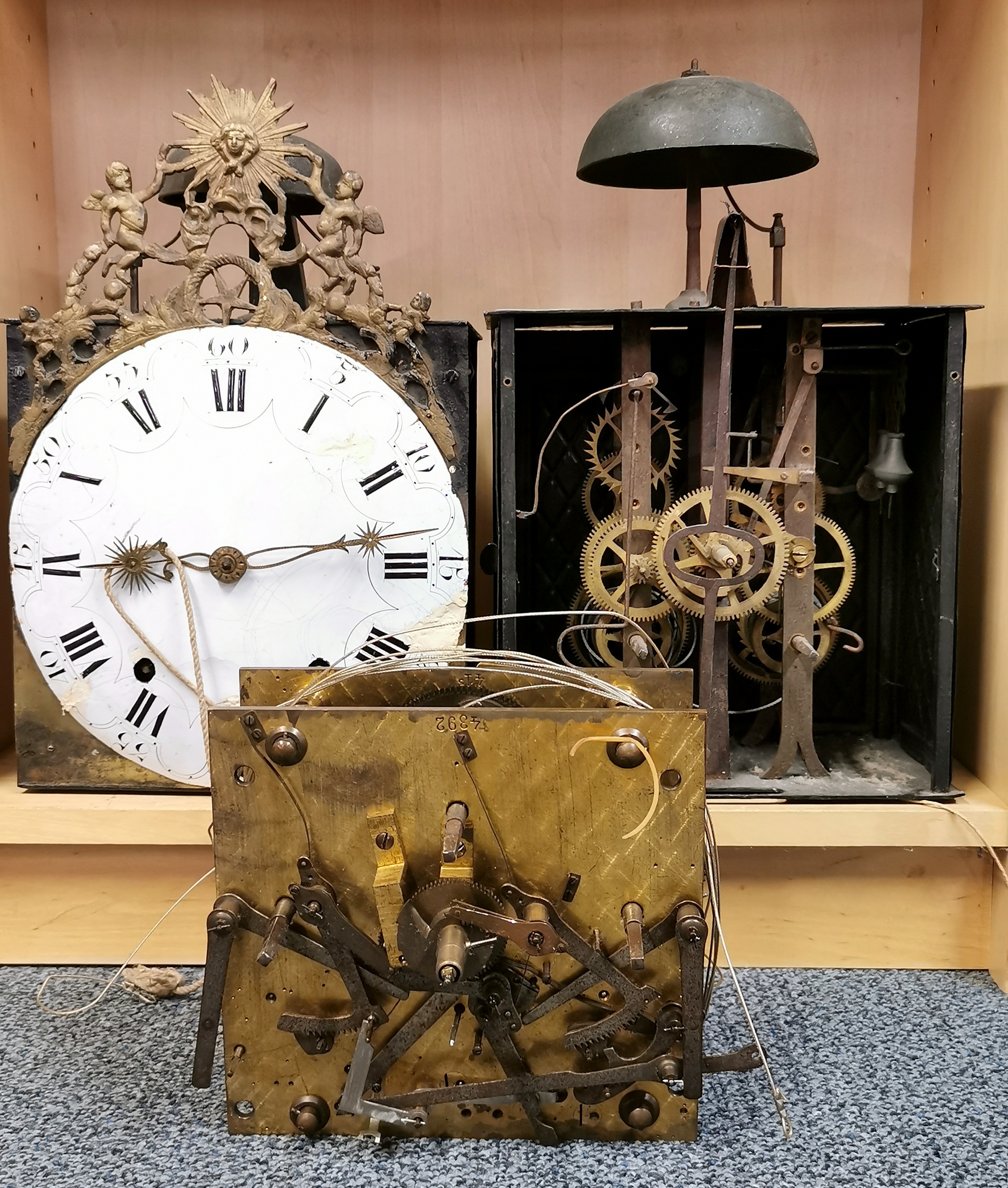 Three 19th century part clock movements, H. 38cm.