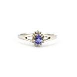 A 9ct white gold cluster ring set with a pear cut tanzanite surrounded by diamonds, (O).