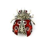 A 925 silver and marcasite enamelled ladybird shaped brooch set with rubies, L. 3cm.
