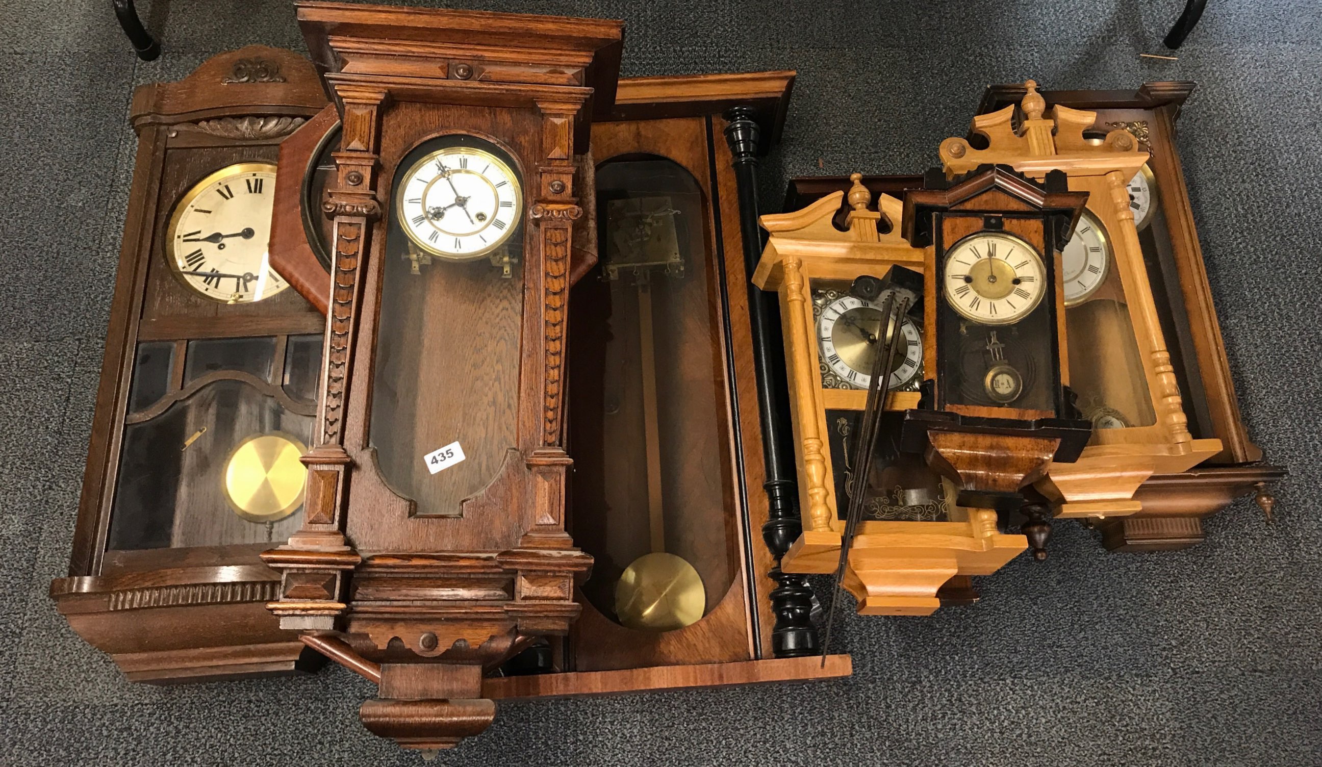 A quantity of Victorian and other wall clocks in various states of repair.