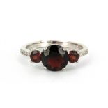 A 925 silver garnet set ring, (O.5).