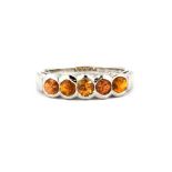 A 9ct white gold citrine set half eternity ring, (O).