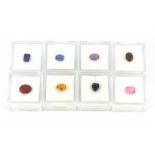 Eight individually boxed unmounted gemstones, including sapphire, pink sapphire, amethyst, etc..