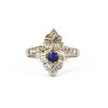 A white metal (tested high carat gold) ring set with a sapphire and brilliant cut diamonds, (Q).