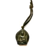 A Tibetan metal mounted clay Buddha amulet, H. 5cm together with a small cast bronze standing figure