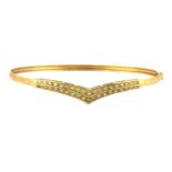 A 9ct yellow gold bangle set with alexandrite, L. 6.5cm.