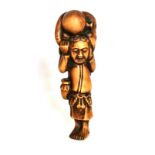 A carved fruitwood netsuke of a man carrying a large octopus on his head, H. 9cm. Condition: good