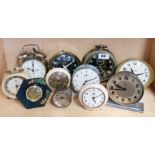 A group of eleven vintage alarm clocks.