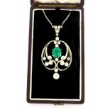 A yellow and white metal (tested gold and silver) pendant set with an emerald cut emerald and old