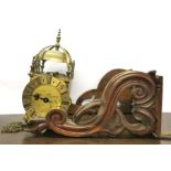 A brass reproduction clock with a mahogany wall bracket, clock H. 38cm.