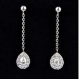 A pair of 900 platinum drop earrings set with pear and brilliant cut diamonds, L. 2.5cm.