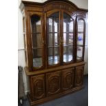 A carved walnut display cabinet, W. 145cm H. 205cm.