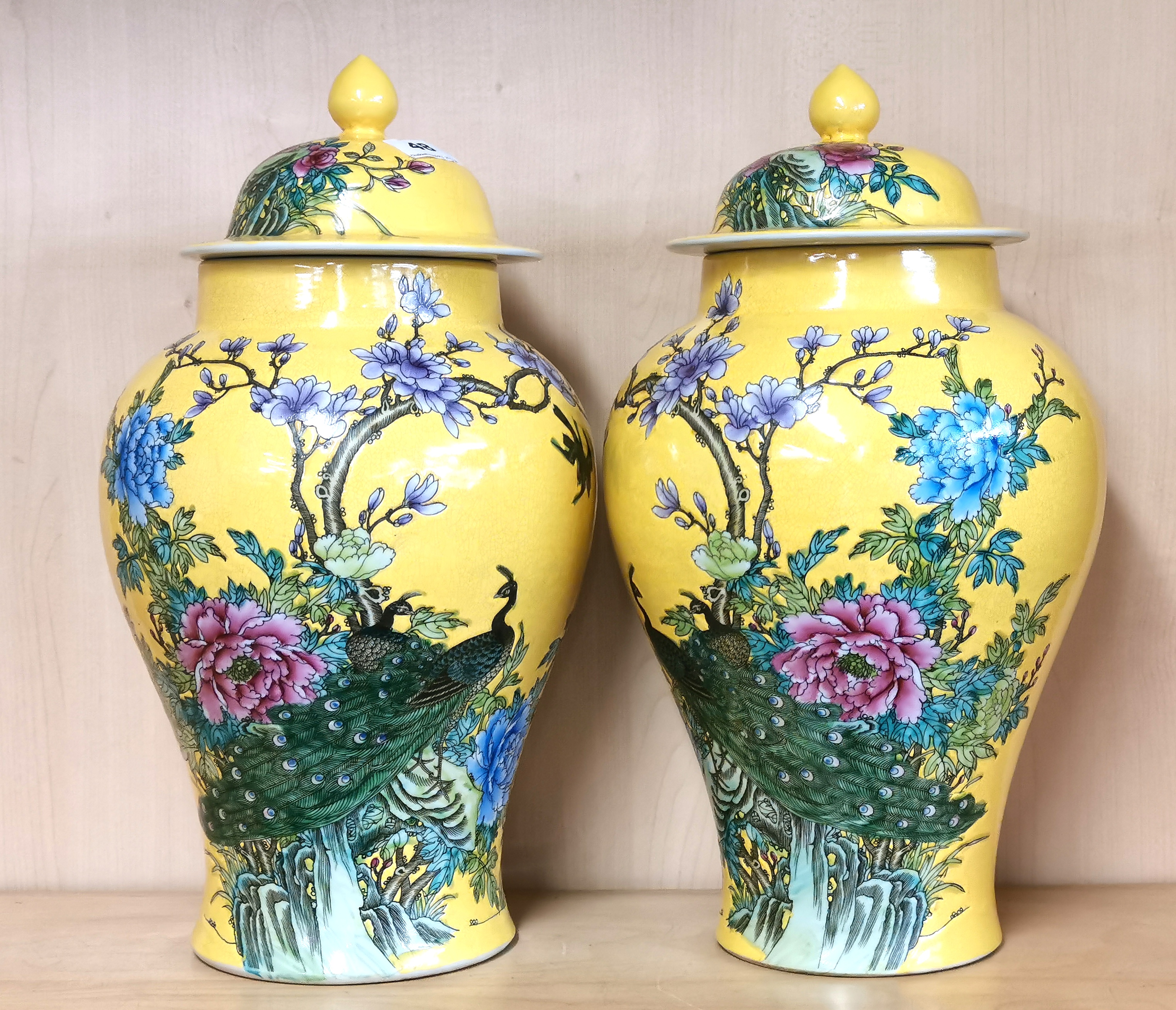 A pair of Chinese hand painted Imperial yellow porcelain jars and lids decorated with peacocks, H. - Image 2 of 5