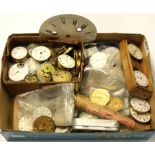 A box of pocket watch movements and parts.