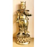 A Sino Tibetan gilt bronze figure of a standing deity on a lotus pedestal, H. 28.5cm. Condition: