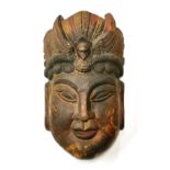 A Chinese carved and painted wooden mask of the goddess Guanyin, H. 38cm. Condition: overall