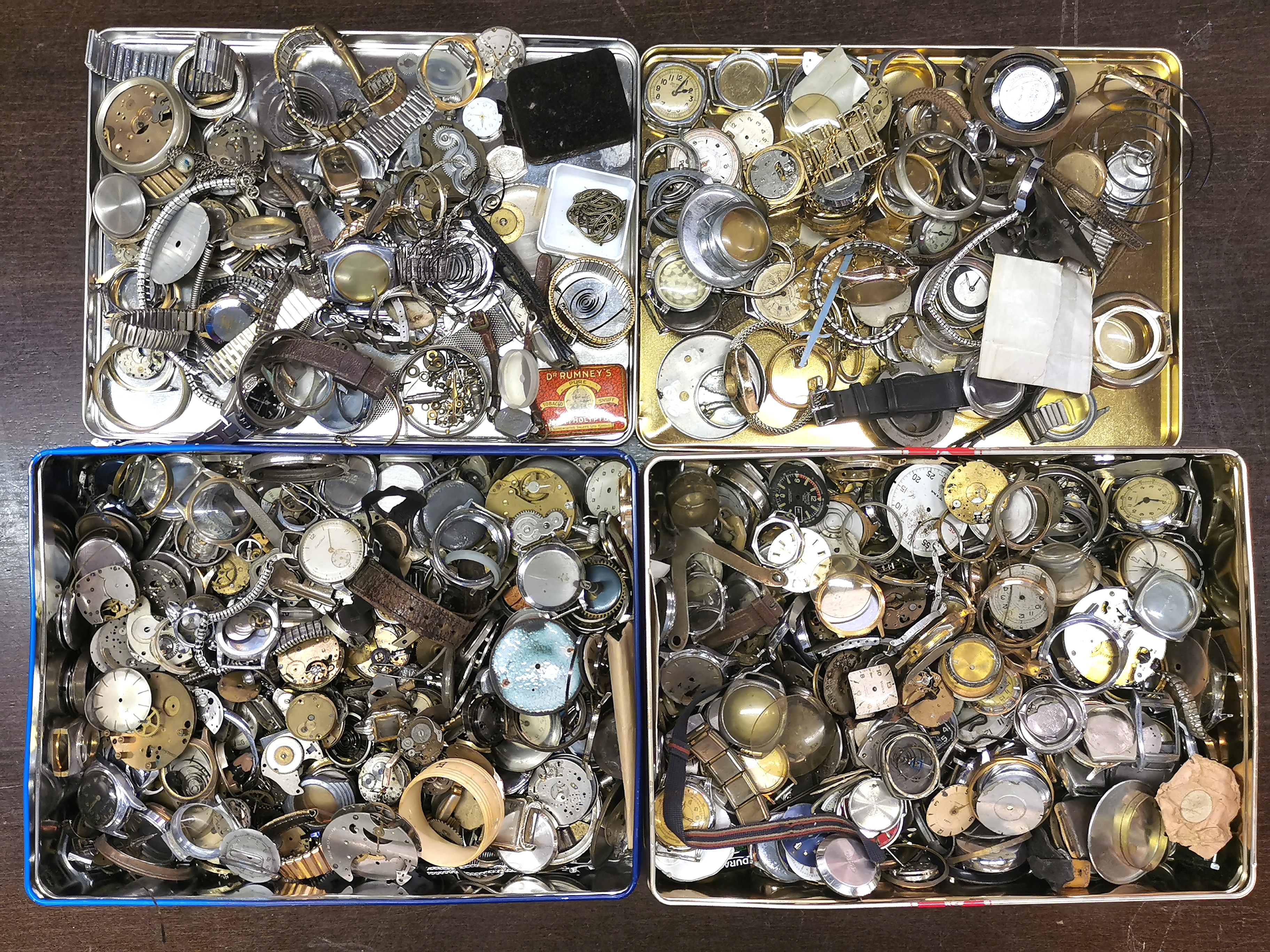 Two tins of watches and watch parts.