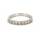 An 18ct white gold diamond set half eternity ring, approx. 0.60ct overall, (L.5).
