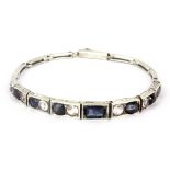 A 1920's white metal (tested silver) sapphire and white topaz set bracelet.