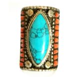 A Tibetan white metal Tribal man's ring set with coral and turquoise, L. 3.7cm. Nickel based