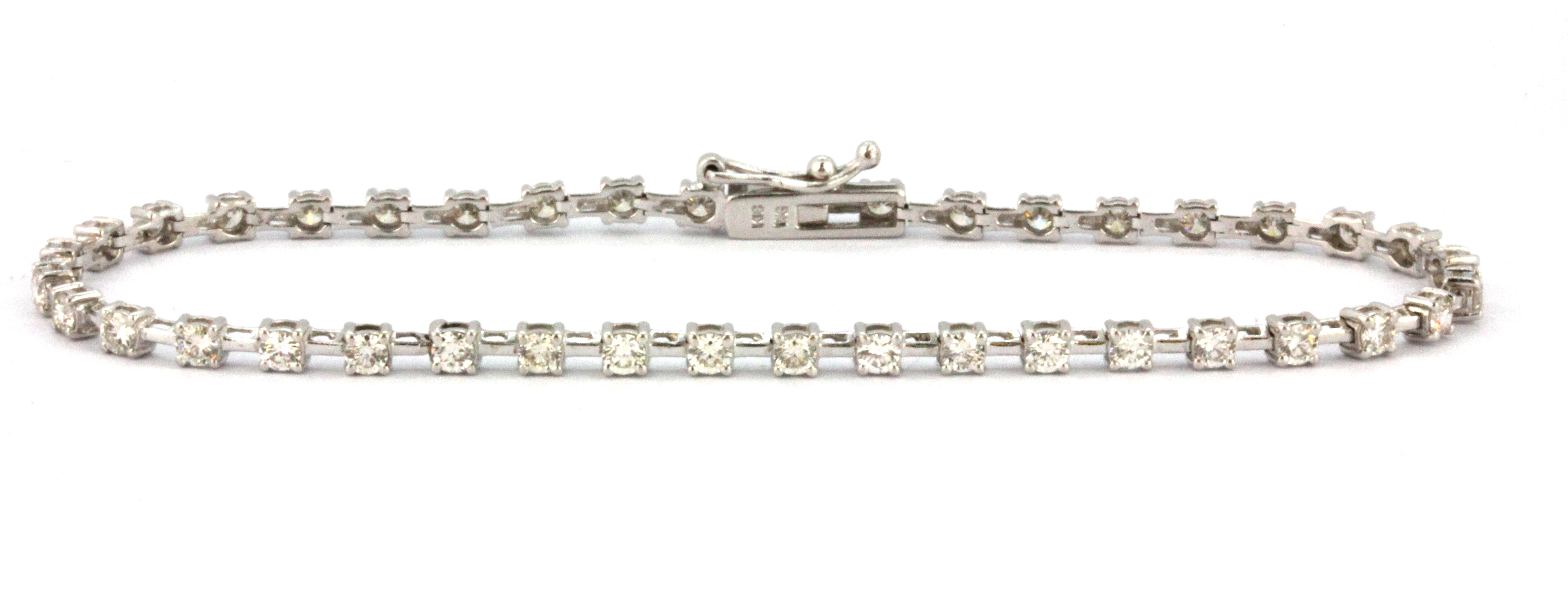 An 18ct white gold (stamped 18k) diamond set line bracelet, approx. 2ct overall, L. 18cm.