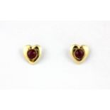 A pair of 9ct yellow gold ruby set heart shaped stud earrings, L. 0.7cm.