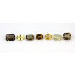 Seven large unmounted citrines and smoky quartz, approx. 70.75ct overall.