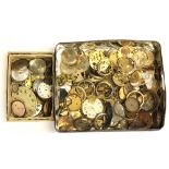 A tin of pocket watch parts, dials etc.