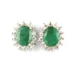 A pair of 925 silver cluster stud earrings set with oval cut emeralds and cubic zirconia, L. 1.2cm.