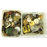 Two tubs of watch and clock movements and parts.