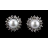 A pair of 18ct white gold (stamped 750) stud earrings set with a large pearl and brilliant cut