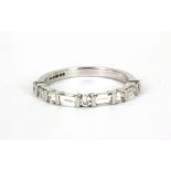 An 18ct white gold (stamped 750) half eternity ring set with baguette and brilliant cut diamonds, (