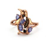 A 925 silver rose gold gilt penguin shaped ring set with tanzanites and black spinels, (S).