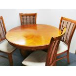 A contemporary circular dining table and four chairs, Dia. 120cm.
