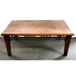 A hardwood and cast iron coffee table, size 110 x 60 x 46cm.