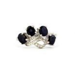 A 925 silver ring set with sapphires and white stones, (M).