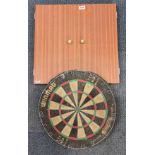 Two vintage dartboards, one unused.