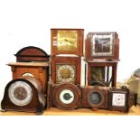 A group of mixed clocks and clock cases.