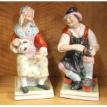 A pair of large early 19th Century Staffordshire pottery figures of the cobbler and his wife, H.