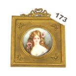 An Edwardian gilt metal framed hand painted miniature of a girl, frame size 10.5 x 12cm.