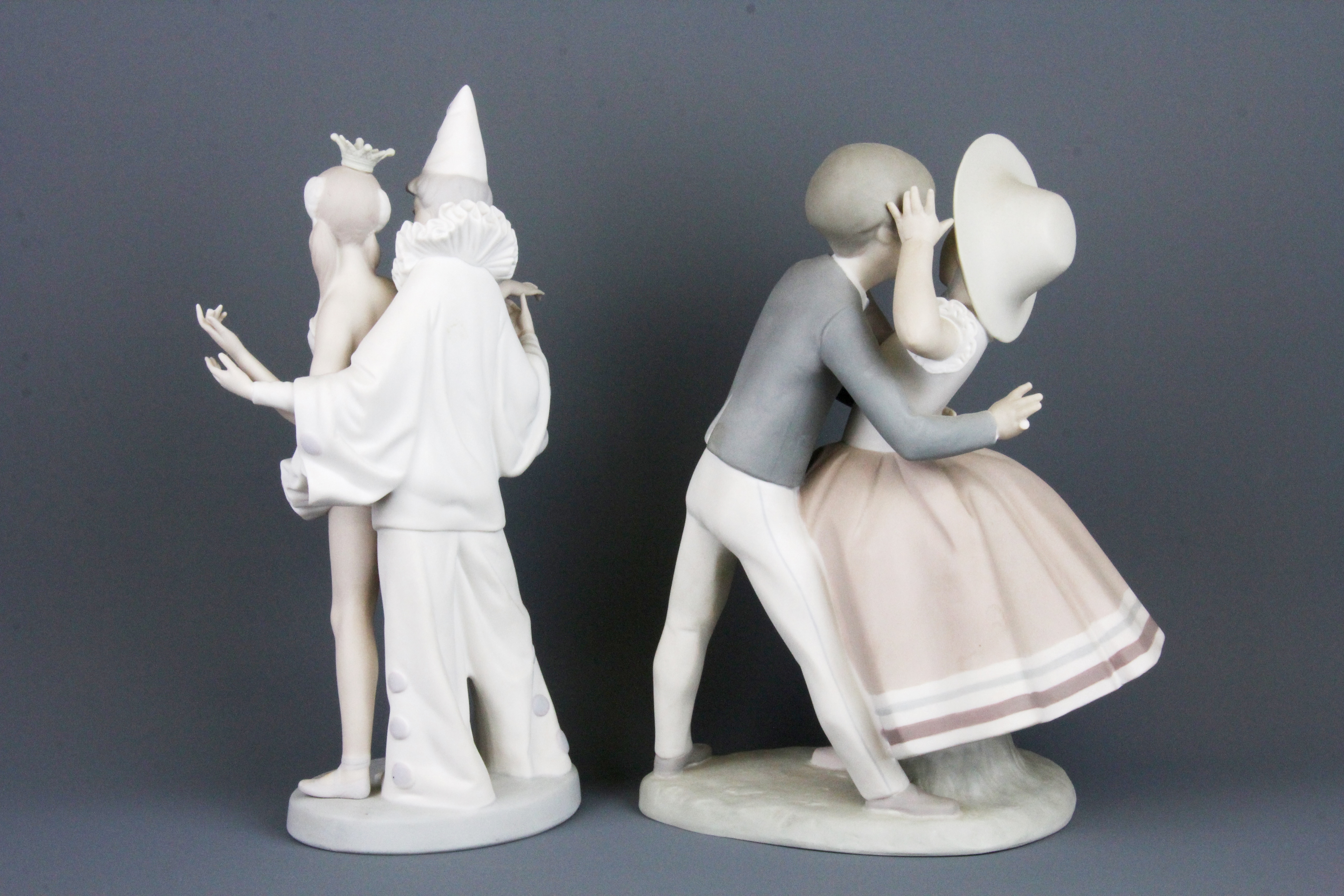 Two Lladro bisque porcelain figures of couples, H. 27, H. 25. Condition: both figures have one - Image 2 of 3