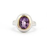 A matching 18ct white gold (stamped 750) ring set with oval cut amethyst, (N).