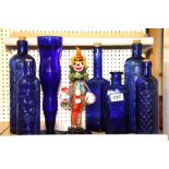 A Murano glass clown, H. 27cm, a glass vase and collection of glass bottles.