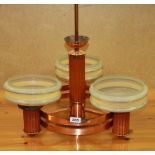 An Art Deco copper three branch ceiling light fitting with three glass shades, W. 55cm H. 58cm.
