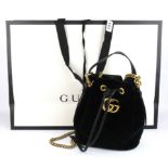 A Gucci Marmont velvet bucket handbag with carrying bag and original label and carrier bag.