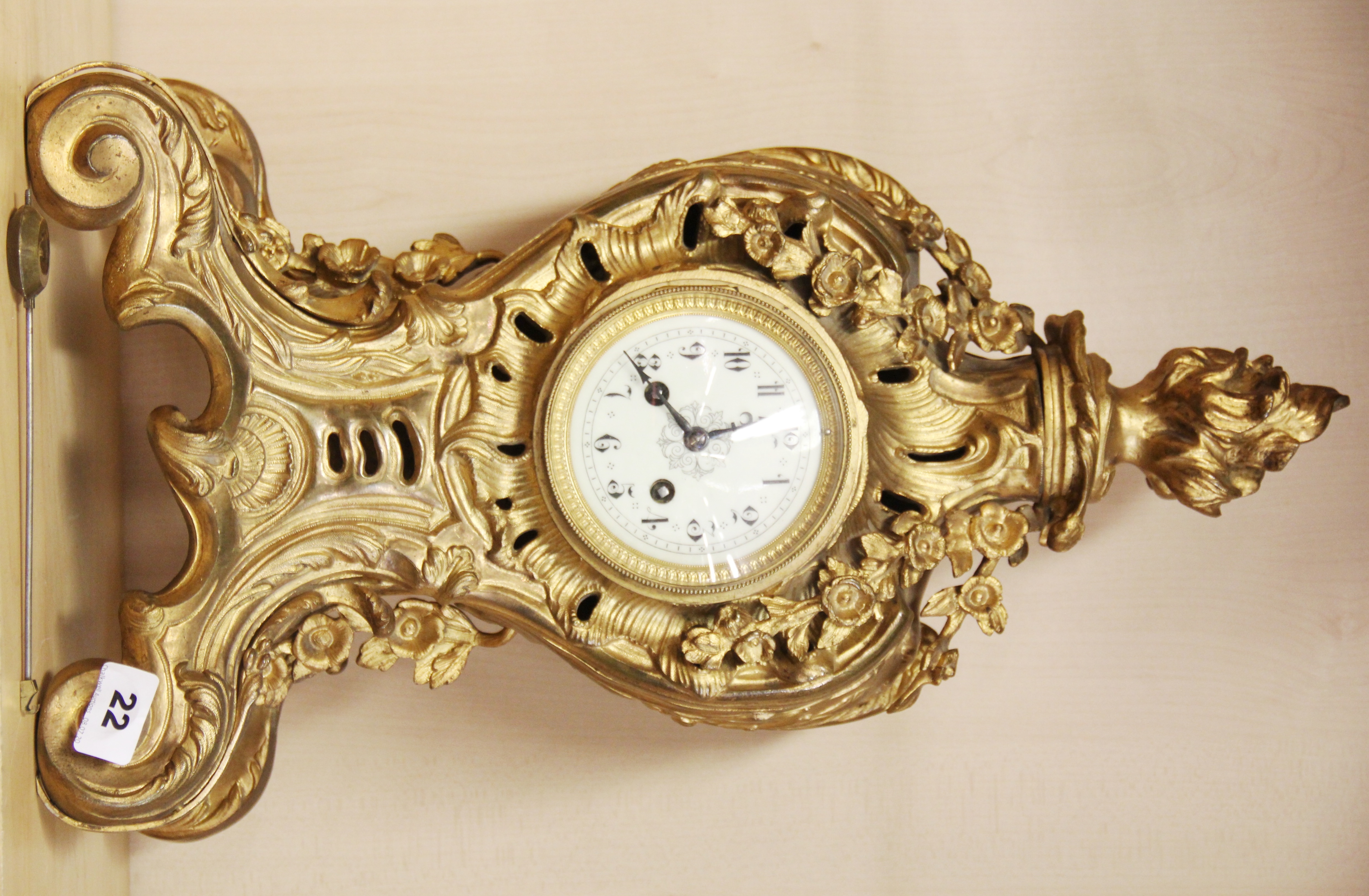 A 19th Century French gilt brass mantle clock with striking movement, H. 51cm. Working condition :