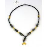 A Tibetan prayer bead necklace of dzi beads, yellow agate and obsidian, folded L. 43cm.